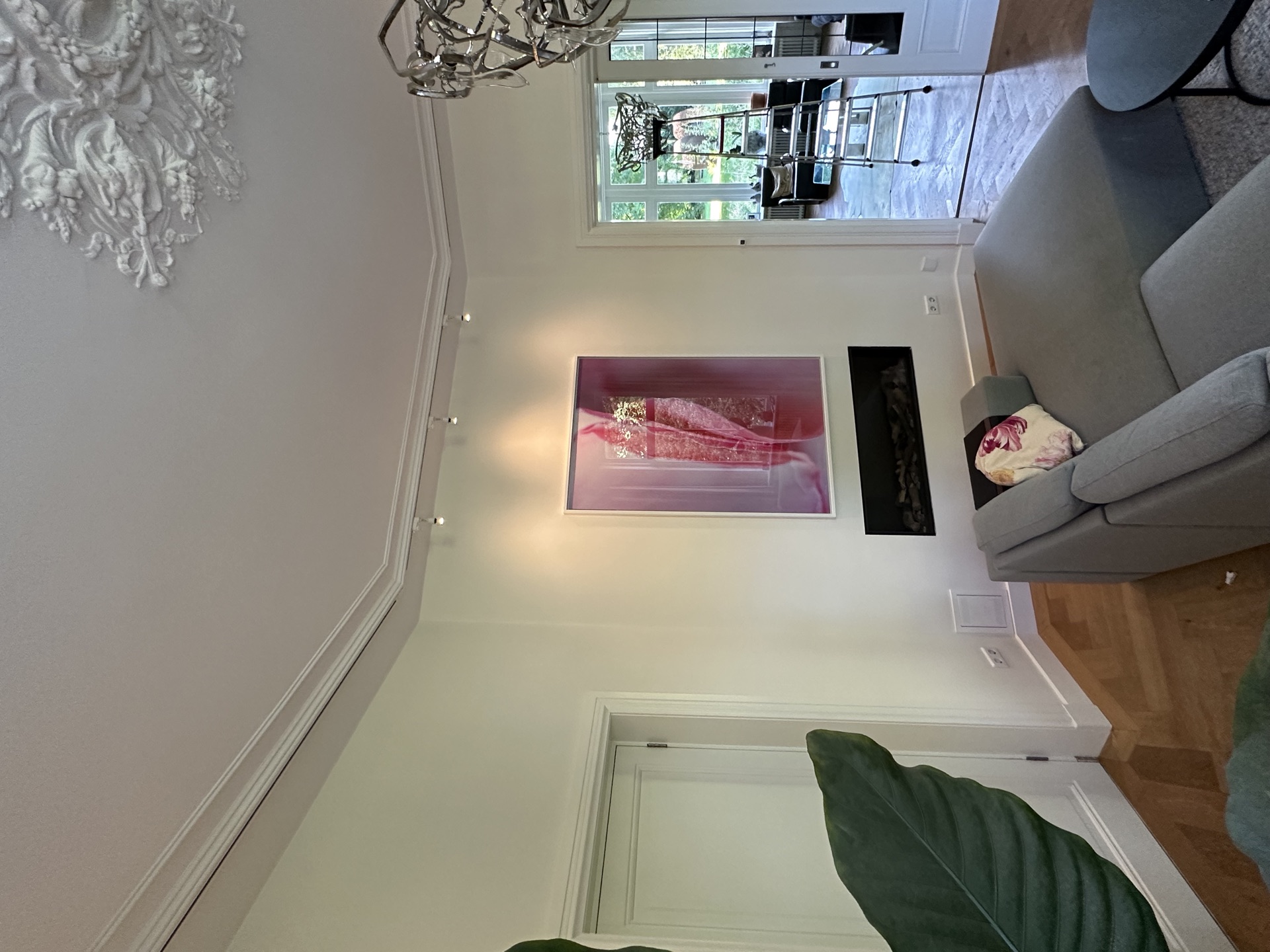 Bloemwerk in ruime witte woonkamer met schouw